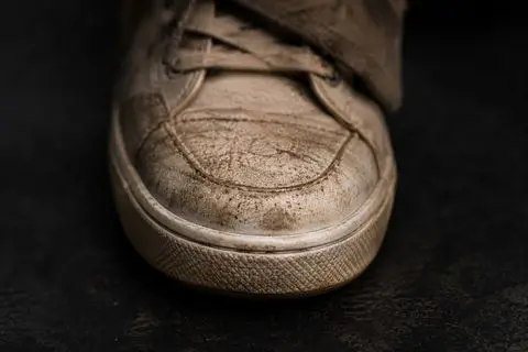 Zbliżenie zabrudzonego czubka sneakersa przed renowacją